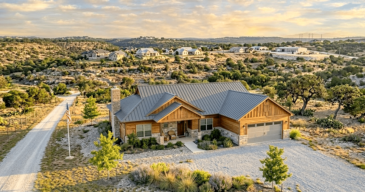 Tuscola Roofers - Luxury Texas ranch home with a brand new metal roof and cedar siding during golden hour in the Jim Ned Valley.