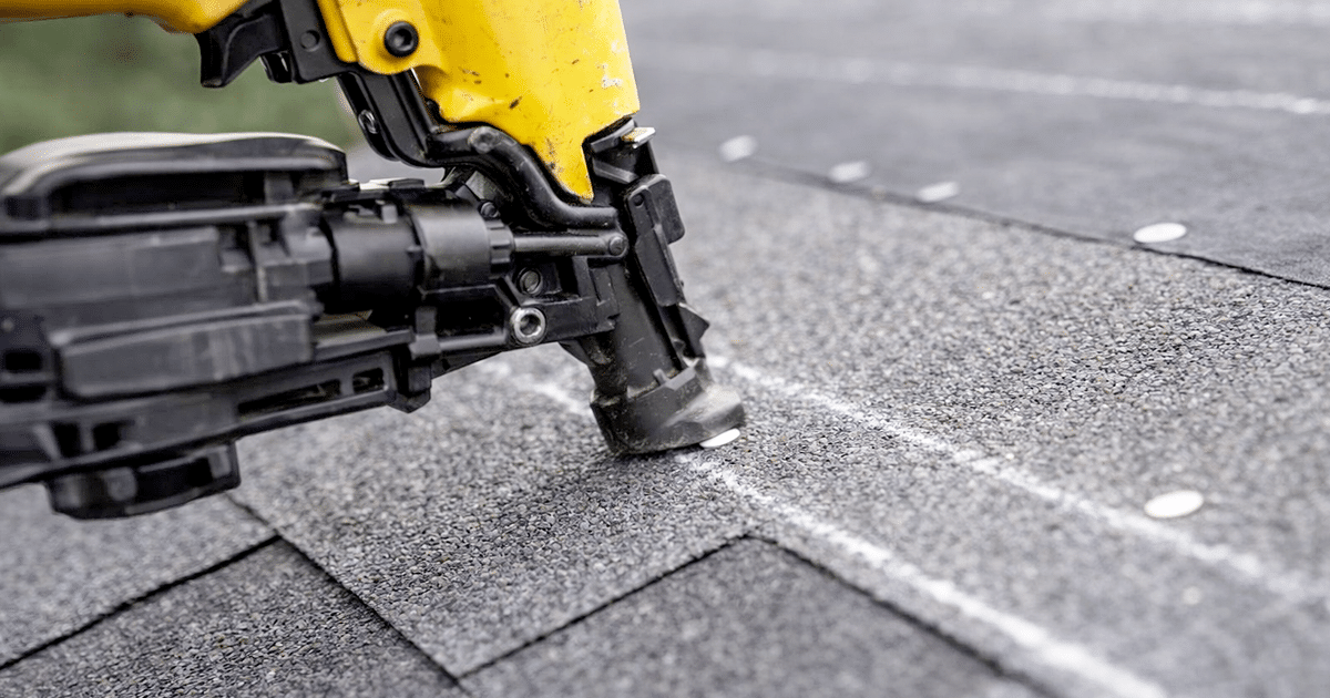 close-up of proper shingle nailing showing nail placement along the nail line using a pneumatic nail gun on asphalt shingles